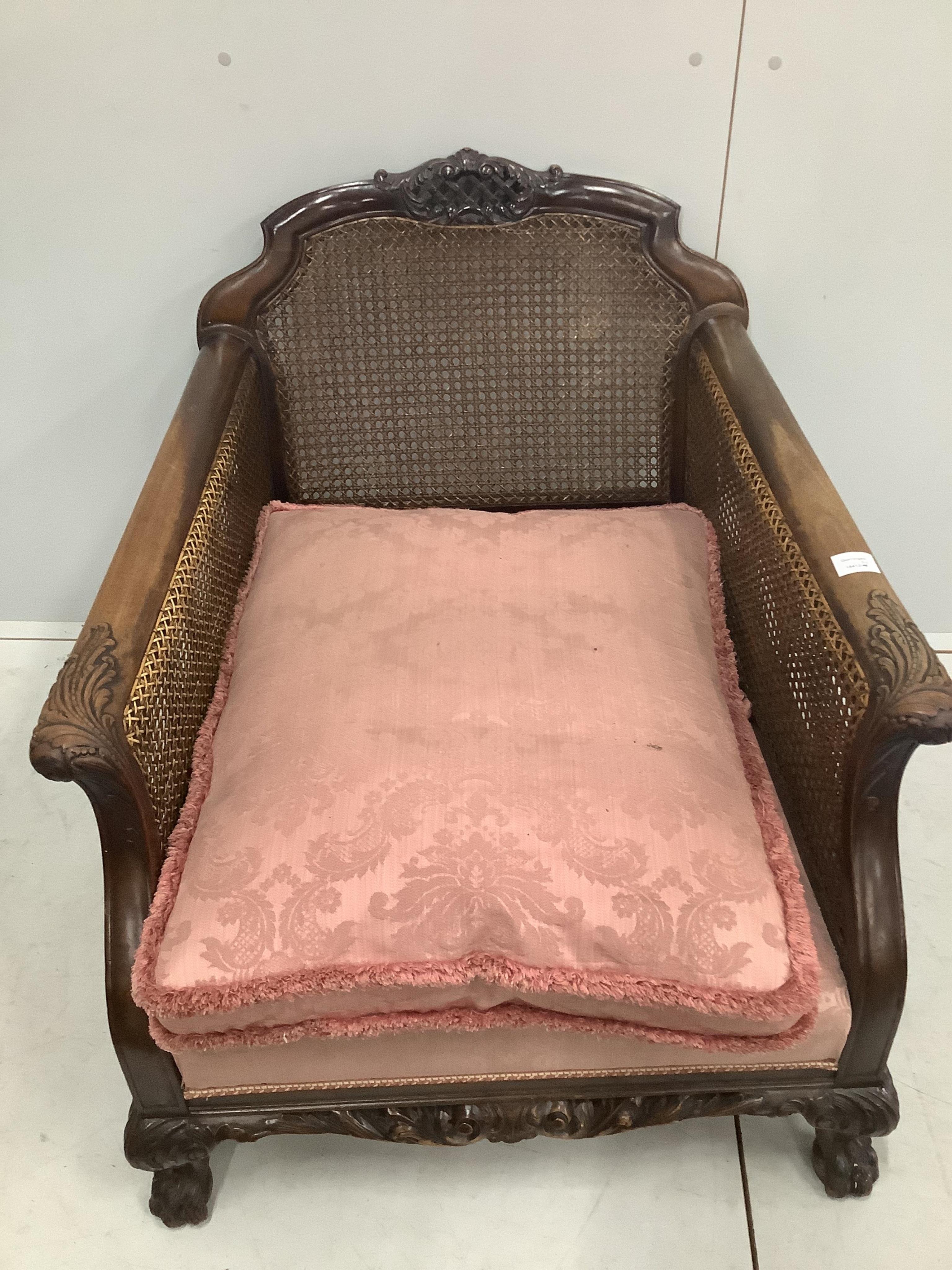 A 1930's mahogany three piece Bergere suite, with double caned arms and single caned backs. Condition - some fading with small damages to the caning